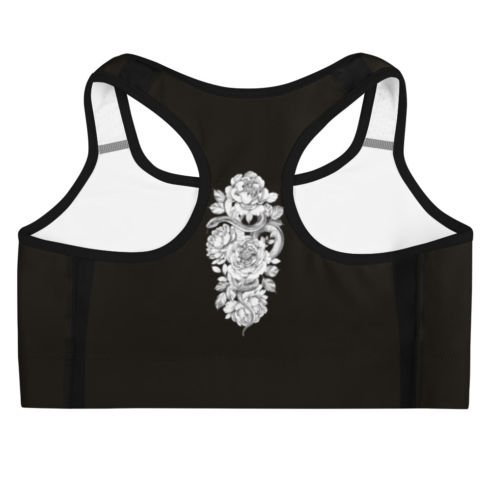 Designed for both style and performance, this sports bra features a stunning white floral pattern against a sleek black backdrop.