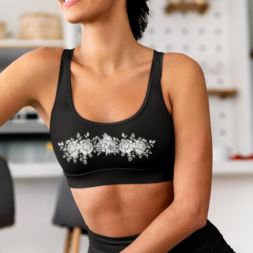 White Floral Black Sports Bra - Woman wearing stylish floral-patterned sports bra during workout lioness-love