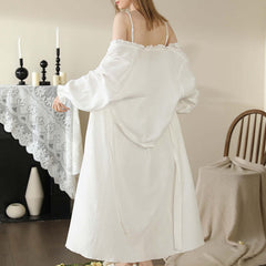 Woman in elegant white cotton lace nightwear standing in cozy home setting