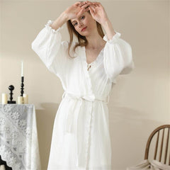 Woman wearing long-sleeve white lace kimono, showcasing elegant loungewear perfect for sleepwear and home comfort.