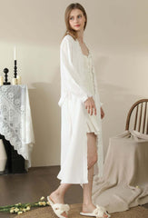 Woman wearing vintage-inspired white cotton lace pajama set with long sleeves, ideal as comfortable home wear and nightwear.