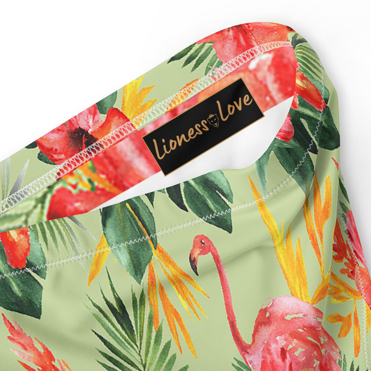 The vibrant green hue is adorned with a delicate floral pattern, adding a fresh and feminine touch to your beach or poolside look. 