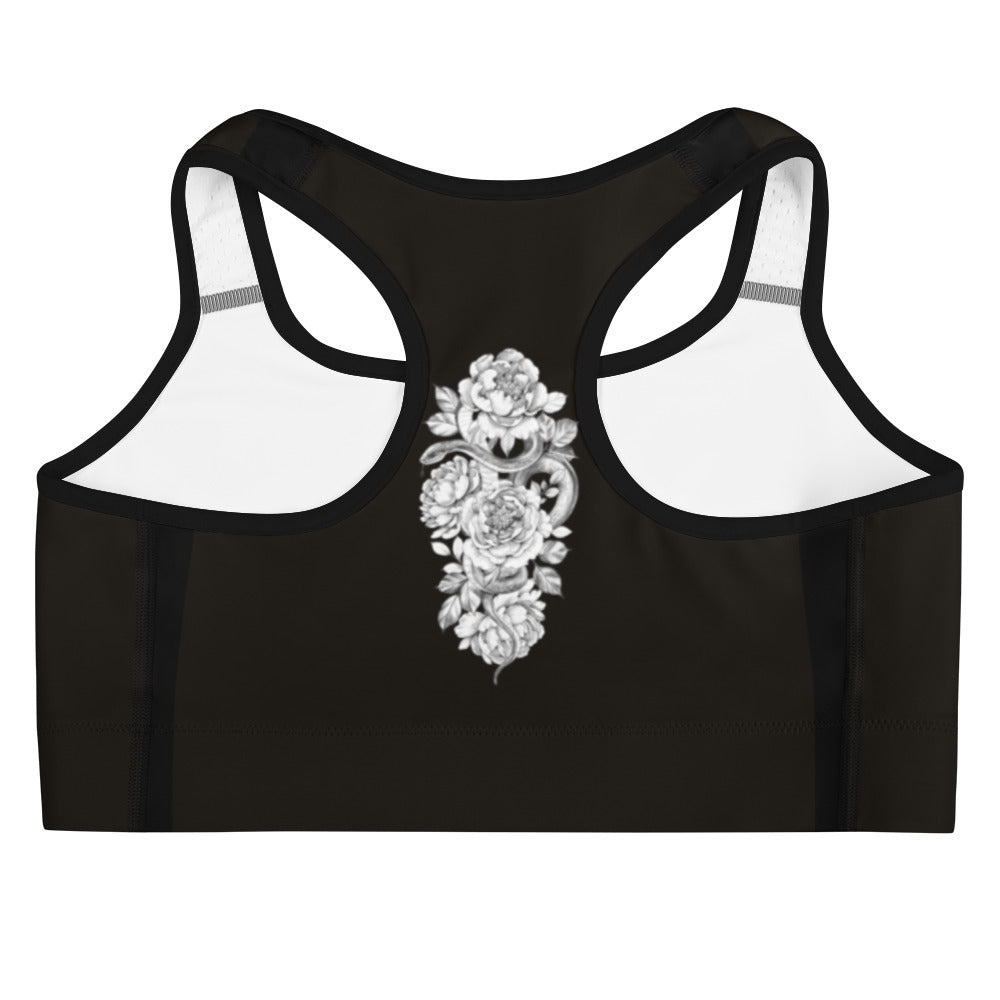 Designed for both style and performance, this sports bra features a stunning white floral pattern against a sleek black backdrop. 